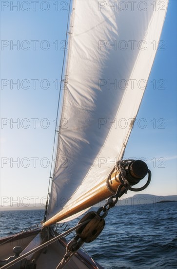 View of sea with yacht bow and sail in foreground. Photo: Daniel Grill