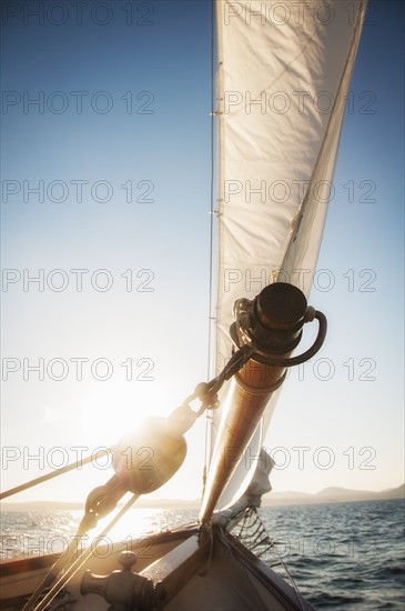 View of sea with yacht bow and sail in foreground. Photo : Daniel Grill