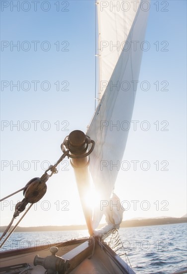 View of sea with yacht bow and sail in foreground. Photo : Daniel Grill