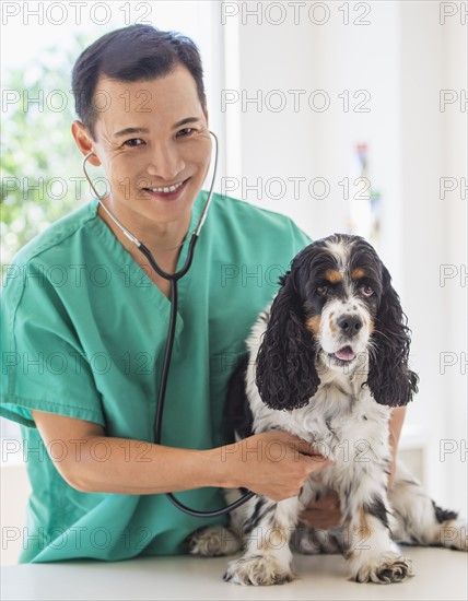 Mid adult vet attending to dog. Photo: Daniel Grill