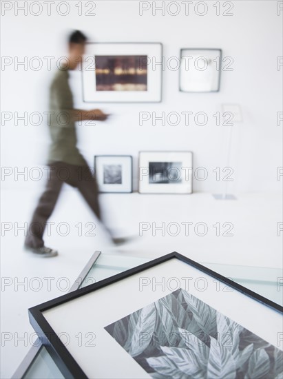 Preparations for new exhibitions in gallery with member of staff moving in background. Photo : Daniel Grill