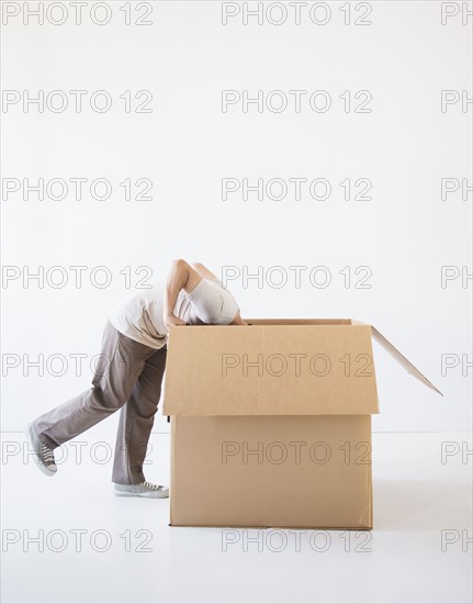 Man hiding inside cardboard box. Photo: Daniel Grill
