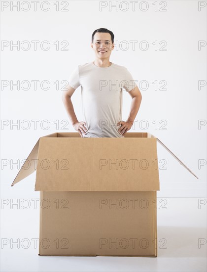 Man popping out from cardboard box. Photo : Daniel Grill