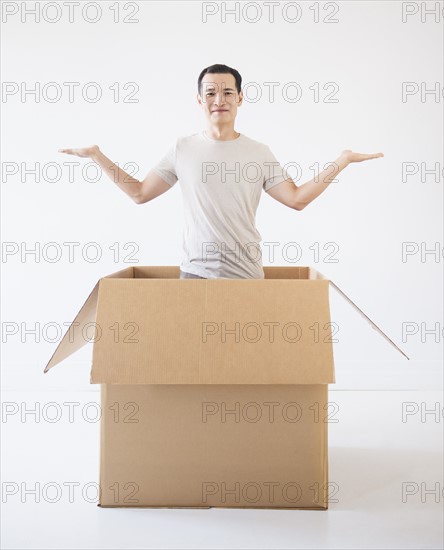 Man popping out from cardboard box. Photo: Daniel Grill