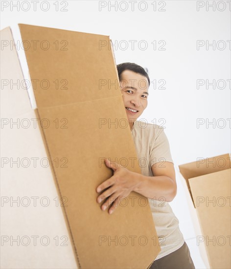 Mid adult moving cardboard boxes. Photo: Daniel Grill