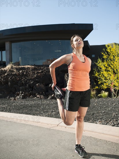 Young woman stretching.