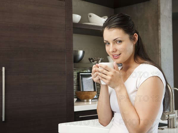 Young attractive woman enjoying her morning cup of coffee. Photo: Erik Isakson
