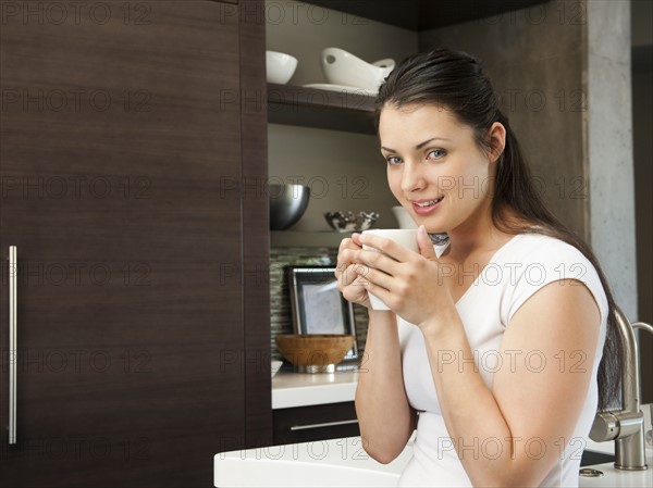 Young attractive woman enjoying her morning cup of coffee.