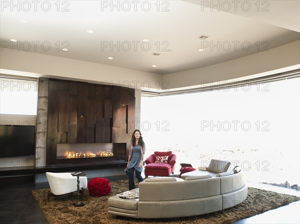 Young woman bustling in modern living room.