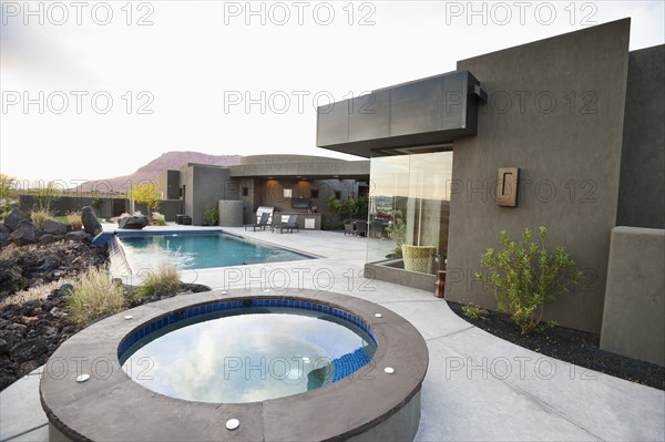 Modern luxury home facing swimming pool.