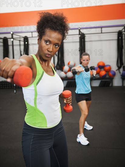 Two mid adult women exercising with dumbbells. Photo: Erik Isakson
