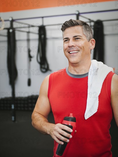 Mature man taking break from exercising.