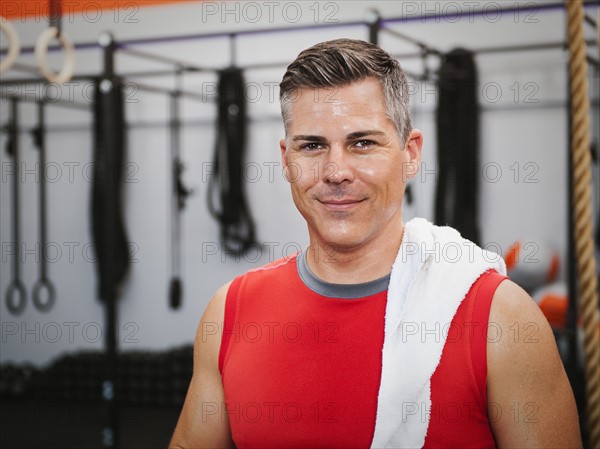 Mature man posing in gym exercising.