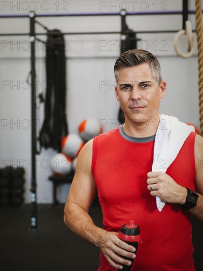 Mature man taking break from exercising.