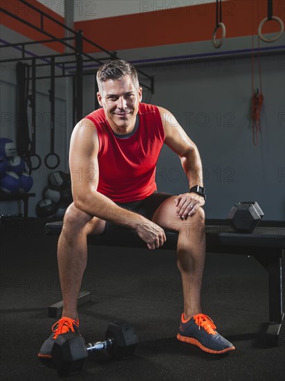 Mature man taking break from exercising .