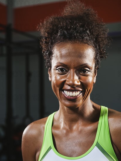 Portrait of happy mid adult woman wearing sports bra. Photo: Erik Isakson