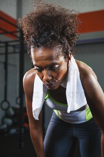 Mid adult woman taking break from exercising.