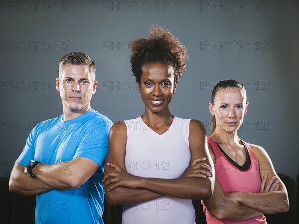 Portrait of three people with crossed arms.