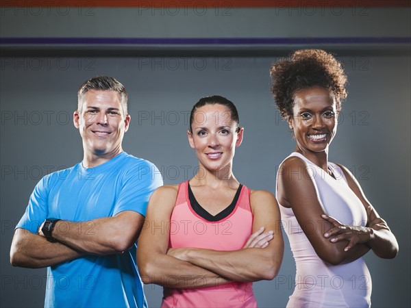 Portrait of three people with crossed arms.