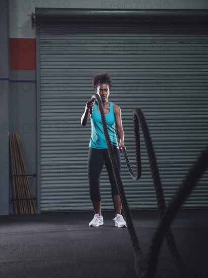 Mid adult woman exercising with rope. Photo: Erik Isakson