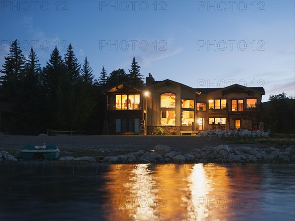 evening view of holiday villa from lake.