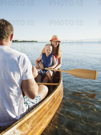 Portrait of young woman with son (4-5) canoe traveling.