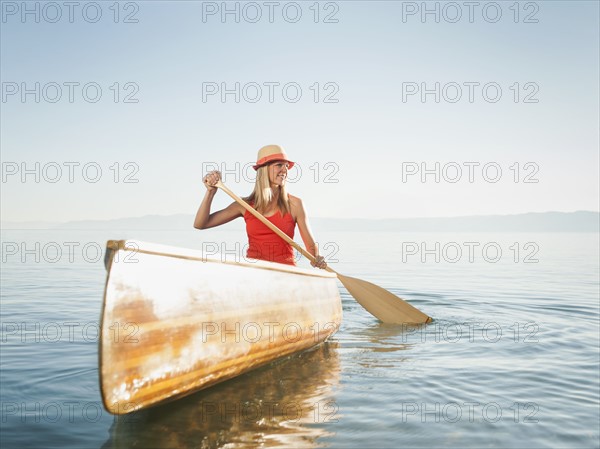Portrait of young woman canoe traveling.