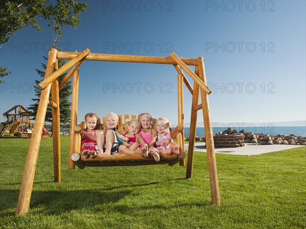 Portrait of children (2-3, 4-5) swinging. Photo: Erik Isakson