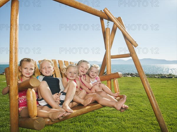 Portrait of children (2-3, 4-5) on swing. Photo: Erik Isakson