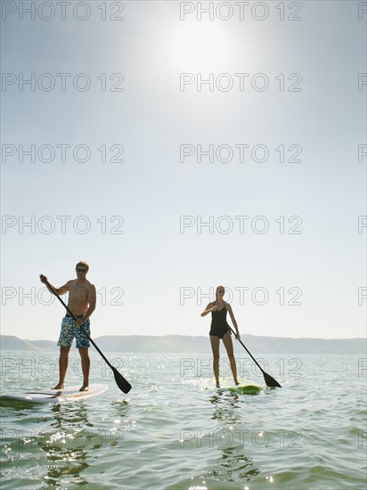 Two people standing on paddleboard. Photo: Erik Isakson