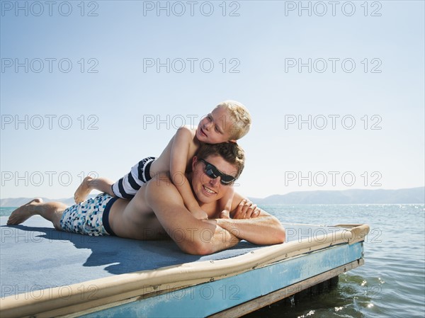 Father with son sunbathing.