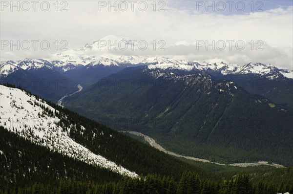 Landscape with mountain range in background. Photo : Tetra Images