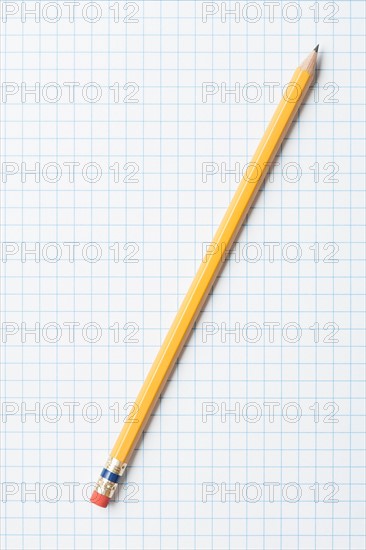 Single yellow sharpened pencil on graph paper. Photo : Kristin Duvall