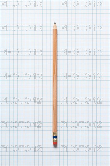 Single wooden sharpened pencil on graph paper. Photo : Kristin Duvall