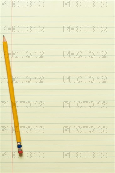 Single yellow sharpened pencil on yellow legal pad. Photo : Kristin Duvall