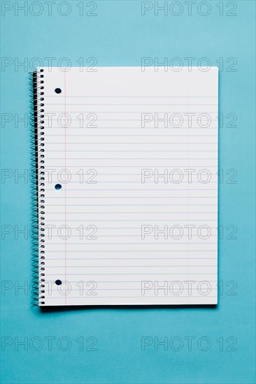 Blank spiral notebook on blue background. Photo: Kristin Duvall