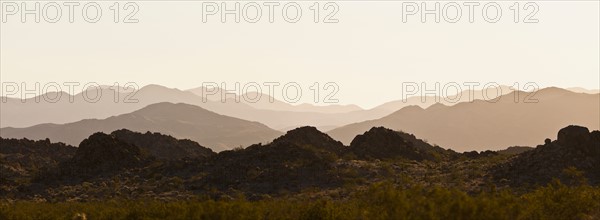 Several mountain ranges backlit by morning sun. Photo : Mike Kemp