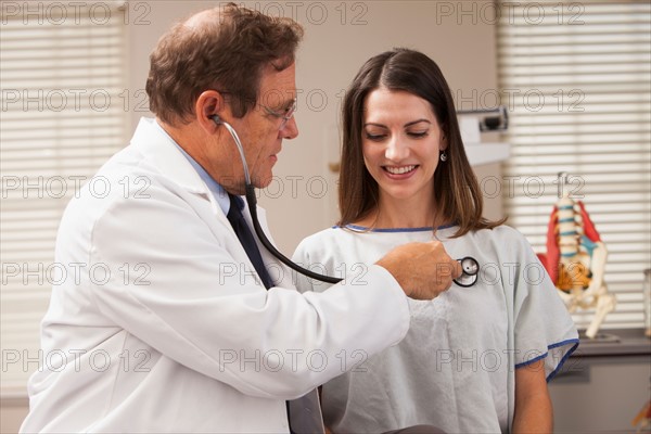 Doctor checking patients heart rate with Stethoscope. Photo : Mike Kemp