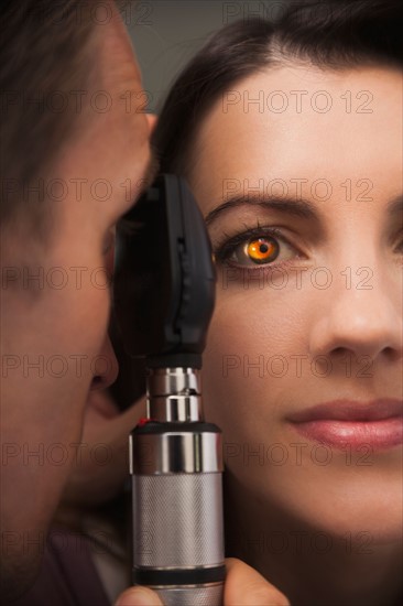 Close up of woman's eye lit up from doctor doing eye test. Photo : Mike Kemp