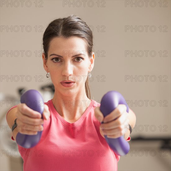 Young woman exercising with elastics. Photo : Mike Kemp