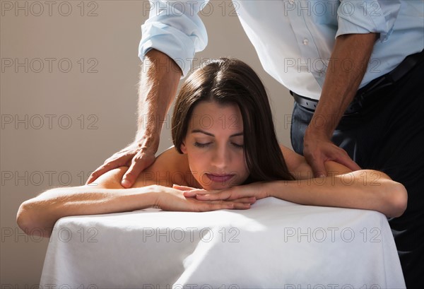 Beautiful young woman getting a massage. Photo : Mike Kemp