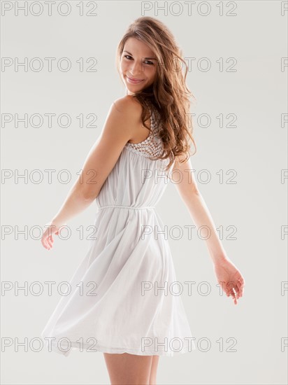 Beautiful woman swinging hips in summer dress. Photo: Mike Kemp
