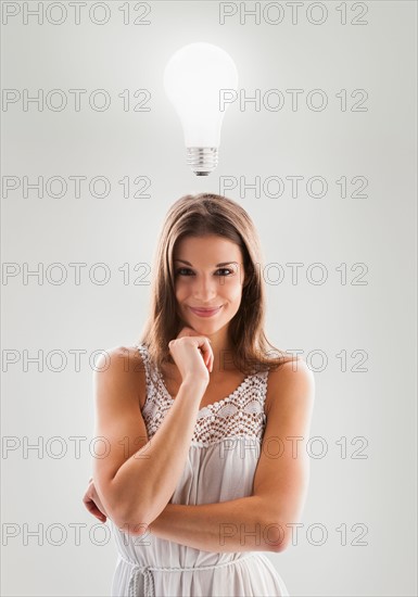 Beautiful woman with lightbulb above her head. Photo: Mike Kemp
