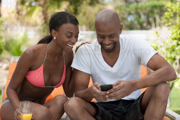 African American couple socializing around pool. Photo: Dan Bannister