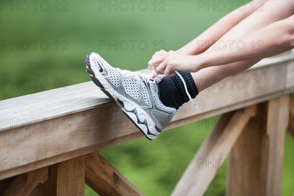 Young woman tying her shoes