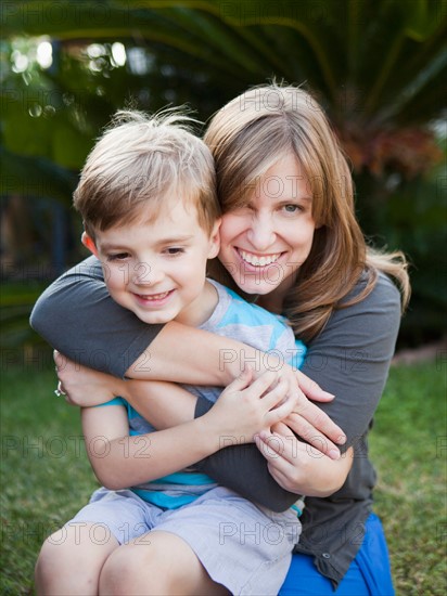 Laughing mother hugging her son. Photo: Jessica Peterson