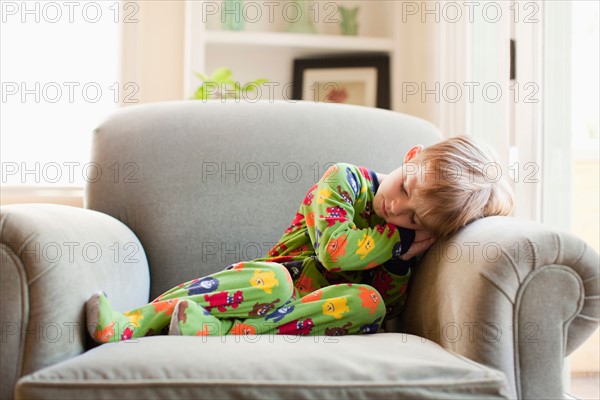 Boy in his pijamas sleeping on armchair. Photo : Jessica Peterson