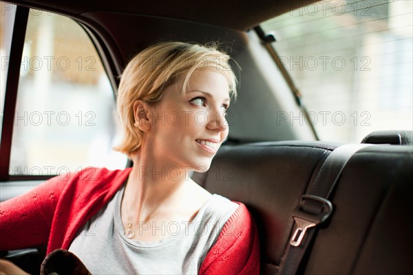 Woman sitting in back seat of car. Photo: Jessica Peterson