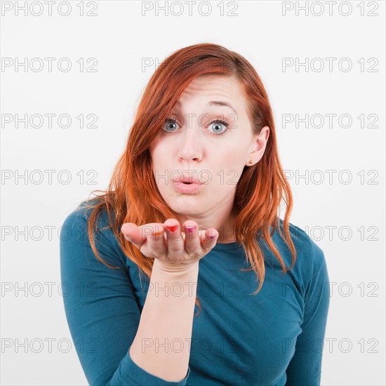 Studio shot, Girl blows kiss. Photo : Jessica Peterson