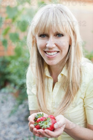 Woman holding strawberries. Photo: Jessica Peterson